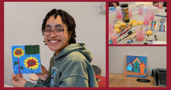 Student holds up their painting from self-care event